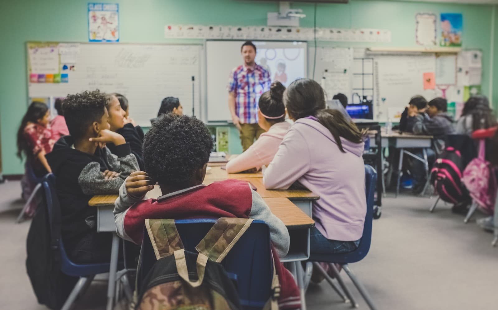 A teacher leading a lesson with students at their desks